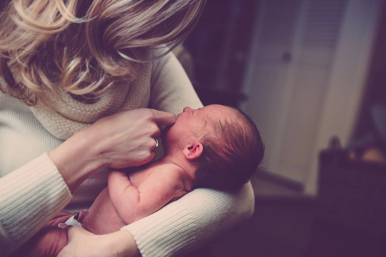A mother holding her newborn baby.